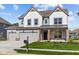 Two-story home with gray siding, white accents, and a three-car garage at 10620 Banyan Wood Ct, Indianapolis, IN 46239