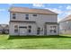 Two-story house with gray siding, multiple windows, and a backyard at 10620 Banyan Wood Ct, Indianapolis, IN 46239