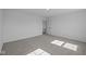 Well-lit bedroom with grey carpet and two windows at 10620 Banyan Wood Ct, Indianapolis, IN 46239