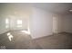 Sunlit bedroom with gray carpet and access to hallway at 7888 Magnolia St, New Palestine, IN 46163