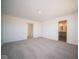 Large bedroom with carpet flooring and access to bathroom and hallway at 7888 Magnolia St, New Palestine, IN 46163