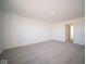 Spacious bedroom with gray carpeting and access to another room at 7888 Magnolia St, New Palestine, IN 46163
