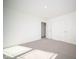 Sunlit bedroom with grey carpet and double doors at 7888 Magnolia St, New Palestine, IN 46163