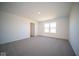 Bright bedroom featuring carpet, window, and access to bathroom at 7888 Magnolia St, New Palestine, IN 46163
