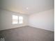 Spacious bedroom with neutral carpeting and large window at 7888 Magnolia St, New Palestine, IN 46163