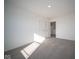 Well-lit bedroom with carpet and doors to other rooms at 7888 Magnolia St, New Palestine, IN 46163