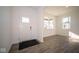 Bright entryway with hardwood floors and a view of a window at 7888 Magnolia St, New Palestine, IN 46163