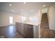 Modern kitchen with island, stainless steel appliances, and access to backyard at 7888 Magnolia St, New Palestine, IN 46163