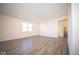Large living area with hardwood floors and access to a bathroom at 7888 Magnolia St, New Palestine, IN 46163