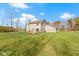 Tan two-story house with deck, attached garage, and expansive lawn at 10341 E Thompson Rd, Indianapolis, IN 46239