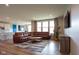 Living room with hardwood floors, a sectional sofa, and a fireplace at 7083 Oak Trce Ln, Brownsburg, IN 46112