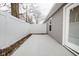 Private back patio with concrete slab and white fence at 1431 Coen Ct, Columbus, IN 47201