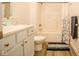 Bathroom with white vanity, tub, shower, and gray rug at 1431 Coen Ct, Columbus, IN 47201