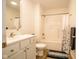 Bathroom with white vanity, toilet and tub shower combo at 1431 Coen Ct, Columbus, IN 47201