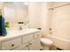 Bathroom with white vanity, toilet, and tub shower combo at 1431 Coen Ct, Columbus, IN 47201