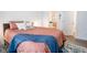 Bright bedroom with coral bedding, blue throw, and en-suite bathroom at 1431 Coen Ct, Columbus, IN 47201