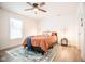 Cozy bedroom with a queen bed, window, and ceiling fan at 1431 Coen Ct, Columbus, IN 47201