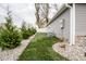 Landscaped yard with side exterior view of the home at 1431 Coen Ct, Columbus, IN 47201