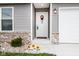 Inviting front entryway with sunflowers and a welcoming wreath at 1431 Coen Ct, Columbus, IN 47201
