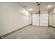 Unfinished garage with concrete floor and overhead door at 1431 Coen Ct, Columbus, IN 47201