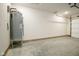 Unfinished garage with concrete floor and overhead door at 1431 Coen Ct, Columbus, IN 47201