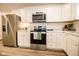 Modern kitchen with stainless steel appliances and white cabinets at 1431 Coen Ct, Columbus, IN 47201