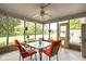 Bright and airy screened porch with seating area and glass windows at 7655 Westerville Dr, Clayton, IN 46118