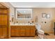 Double vanity bathroom with large mirror and wooden cabinets at 4525 S Deck Rd, Gosport, IN 47433