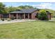 Brick ranch house with a screened porch and landscaped front yard at 4525 S Deck Rd, Gosport, IN 47433