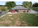 Backyard view of home with fire pit and partially-brown lawn at 4525 S Deck Rd, Gosport, IN 47433