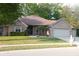 Brick ranch house with two-car garage and landscaping at 466 Sycamore Ridge Ct, Avon, IN 46123