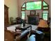Relaxing living room featuring a fireplace and large windows offering wooded views at 466 Sycamore Ridge Ct, Avon, IN 46123