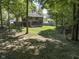 House with deck and large backyard surrounded by trees at 5826 Winding Way Ln, Indianapolis, IN 46220