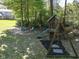 Large backyard with playset, fire pit, and seating area at 5826 Winding Way Ln, Indianapolis, IN 46220