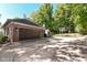 Brick garage with dark brown doors, spacious driveway, and basketball court at 5826 Winding Way Ln, Indianapolis, IN 46220
