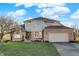 Two-story house with brick and siding exterior, attached garage, and landscaping at 495 Rodeo Dr, Indianapolis, IN 46217