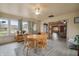 Bright sunroom with a wooden table and chairs, offering views of the backyard at 1061 Saint Paul St, Shelbyville, IN 46176
