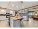 Open concept kitchen with island, white cabinets, and a view into the living room at 1061 Saint Paul St, Shelbyville, IN 46176