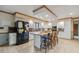 Eat-in kitchen with white cabinets, black appliances, and a large island at 1061 Saint Paul St, Shelbyville, IN 46176