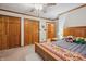 Main bedroom with a wooden bed frame and built-in closet at 1061 Saint Paul St, Shelbyville, IN 46176