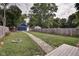 Large backyard with a fire pit, stone path, and detached garage at 1229 N Keystone Ave, Indianapolis, IN 46201