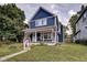 Two-story blue house with porch and landscaping at 1229 N Keystone Ave, Indianapolis, IN 46201