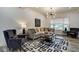 Spacious living room with hardwood floors, large windows, and comfortable seating at 1229 N Keystone Ave, Indianapolis, IN 46201