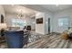 Open concept living room with hardwood floors and a view into the kitchen at 1229 N Keystone Ave, Indianapolis, IN 46201