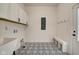 Convenient laundry room with built-in bench and modern flooring at 1229 N Keystone Ave, Indianapolis, IN 46201