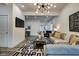 Modern living room with gray sectional sofa and statement lighting at 1229 N Keystone Ave, Indianapolis, IN 46201