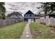 Spacious backyard with a stone path, fire pit, and a view of the house at 1229 N Keystone Ave, Indianapolis, IN 46201