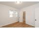 Bedroom with hardwood floors, two windows, and en-suite bathroom at 309 N Lasalle St, Indianapolis, IN 46201