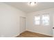 Simple bedroom with hardwood floors and two windows at 309 N Lasalle St, Indianapolis, IN 46201