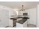 Modern kitchen with white cabinets, island, and stainless steel appliances at 309 N Lasalle St, Indianapolis, IN 46201